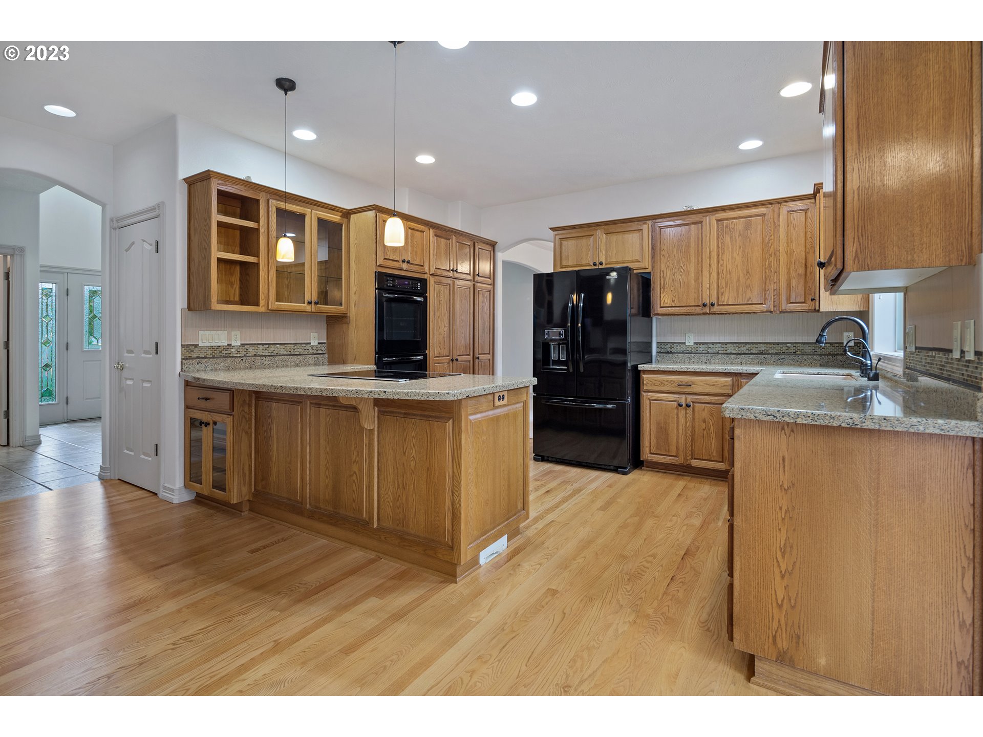 1236 Southeast 26th Drive Gresham, OR 97080 - Photo 11 of 48 a kitchen with stainless steel appliances granite countertop a stove refrigerator and cabinets