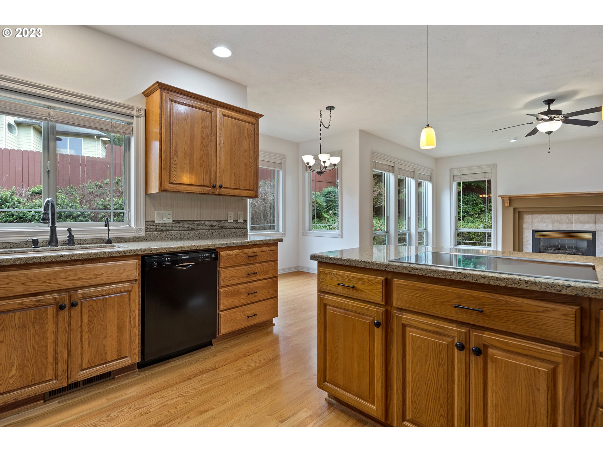 1236 Southeast 26th Drive Gresham, OR 97080 - Photo 13 of 48 a kitchen with stainless steel appliances granite countertop a sink and wooden cabinets