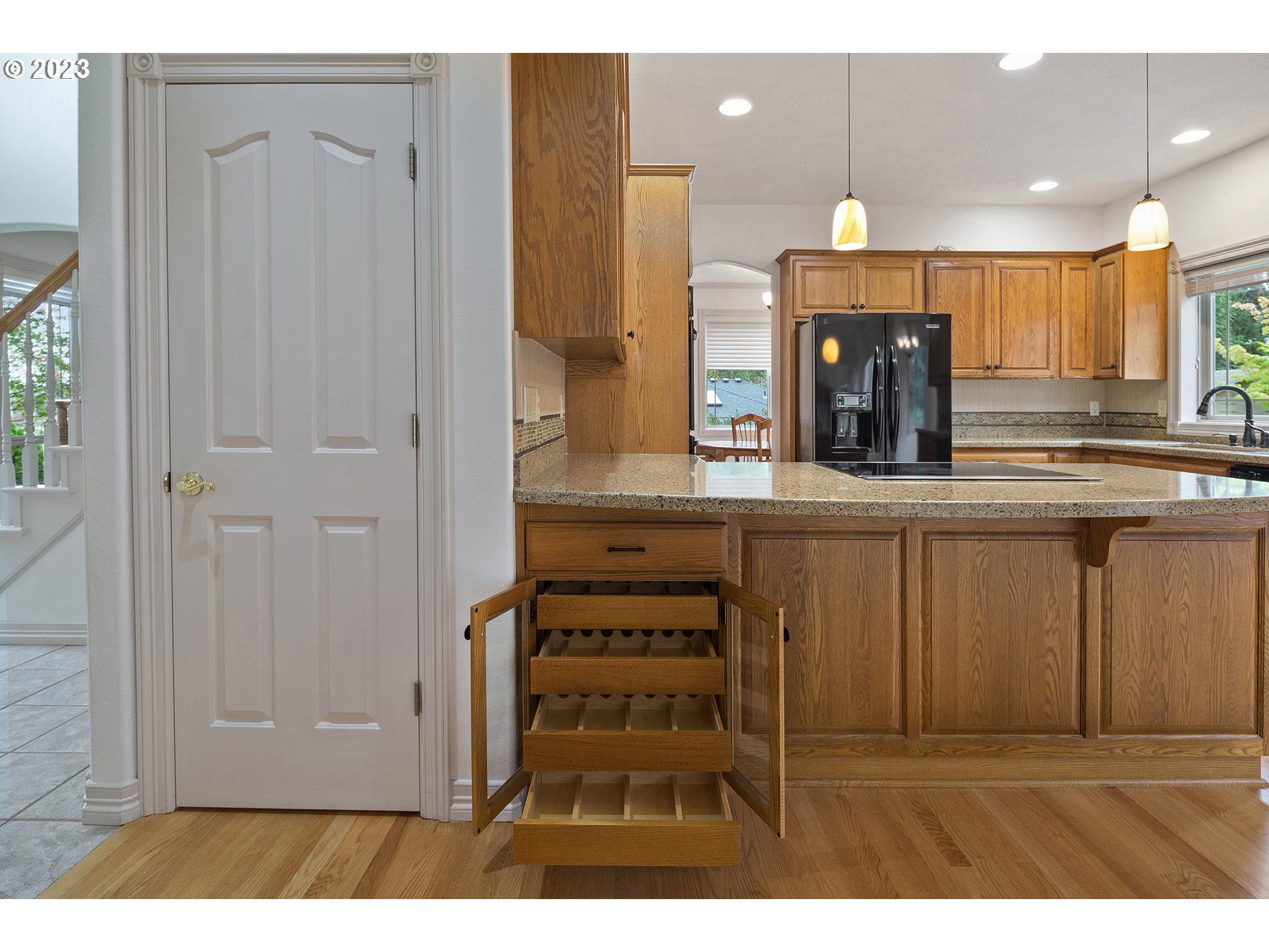 1236 Southeast 26th Drive Gresham, OR 97080 - Photo 15 of 48 a kitchen with kitchen island granite countertop a sink cabinets and stainless steel appliances