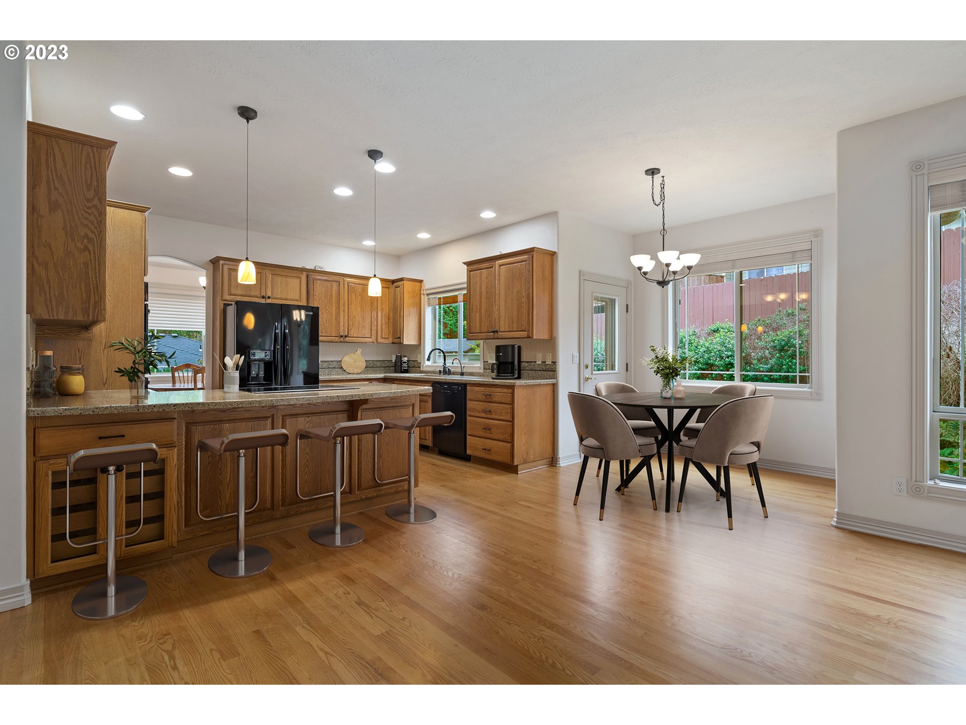 1236 Southeast 26th Drive Gresham, OR 97080 - Photo 17 of 48 a kitchen with a dining table chairs wooden floor appliances and cabinets