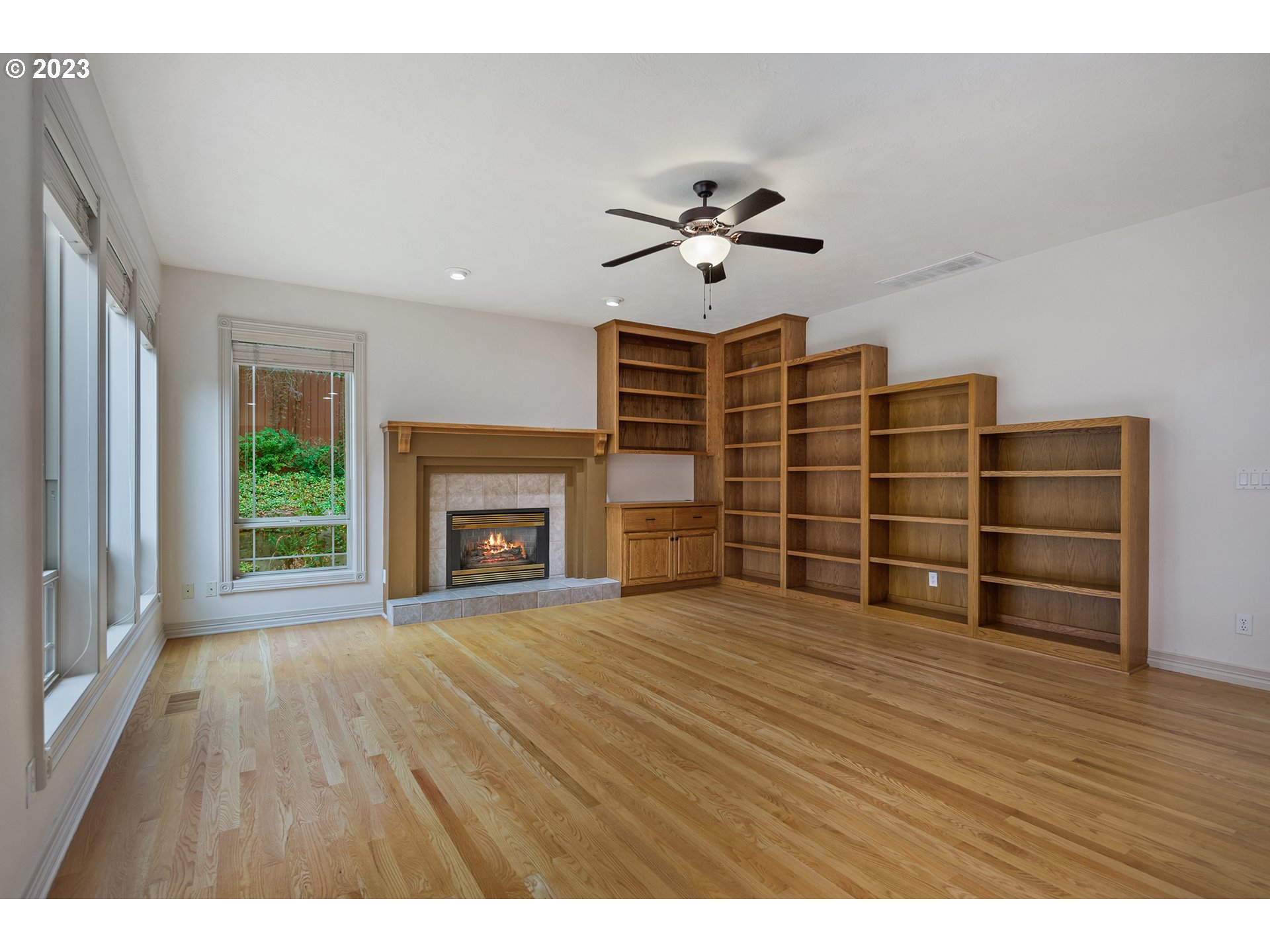 1236 Southeast 26th Drive Gresham, OR 97080 - Photo 20 of 48 a view of empty room with wooden floor and fireplace