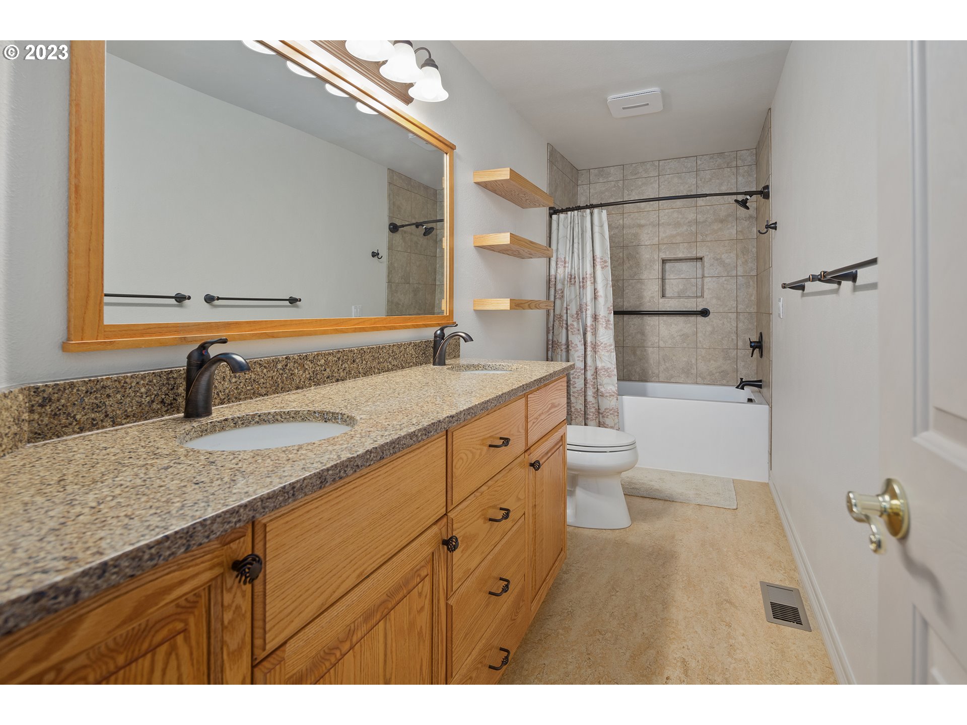 1236 Southeast 26th Drive Gresham, OR 97080 - Photo 37 of 48 a spacious bathroom with a granite countertop sink a toilet a mirror and shower