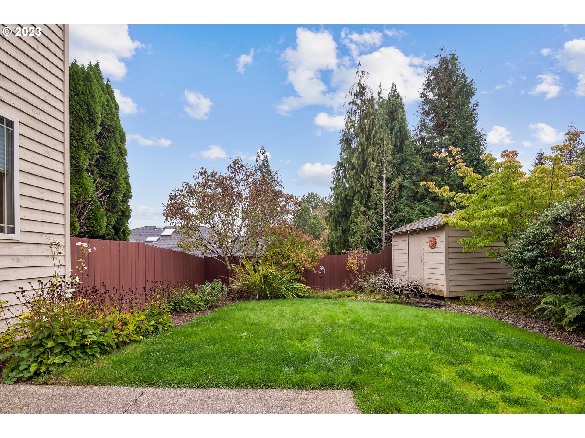1236 Southeast 26th Drive Gresham, OR 97080 - Photo 44 of 48 a view of a backyard with potted plants and large trees
