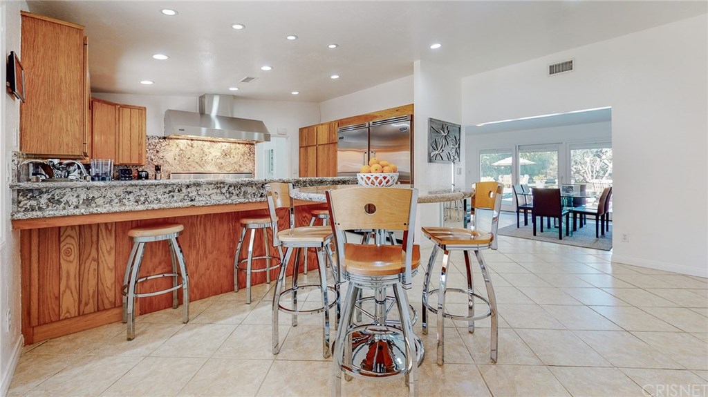 26127 Millstream Drive Canyon Country, CA 91387 - Photo 10 of 68 Custom matching granite high-bar eating area