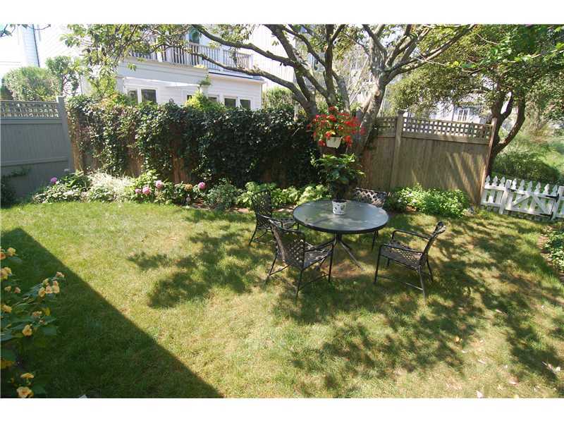 3 Yarmouth Road Rowayton, CT 06853 - Photo 3 of 15 a backyard of a house with a yard and outdoor seating