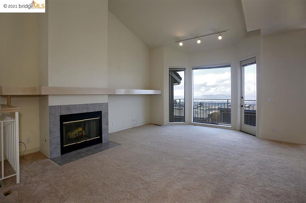 27 Windward Hill Oakland, CA 94618 - Photo 3 of 16 a view of an empty room with a fireplace and a window