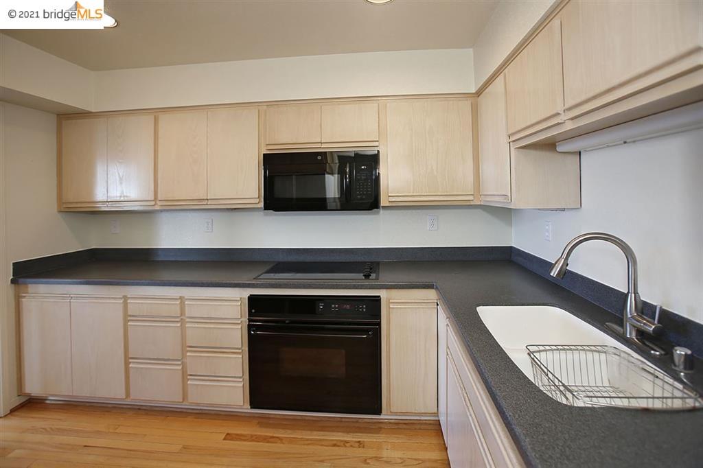 27 Windward Hill Oakland, CA 94618 - Photo 7 of 16 a kitchen with granite countertop a stove a sink and a microwave