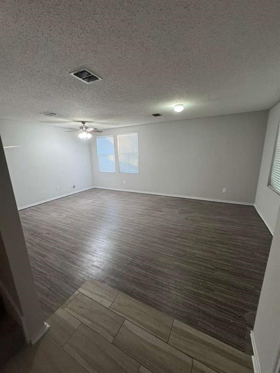 16516 Jasmine Springs Drive Fort Worth, TX 76247 - Photo 12 of 16 an empty room with wooden floor and windows