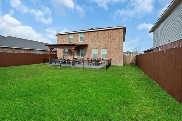 a view of a house with a yard and sitting area