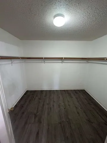 an empty room with wooden floor