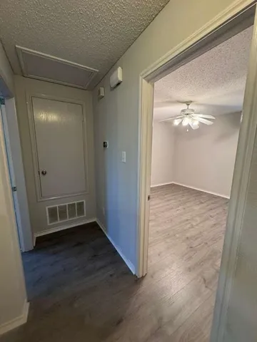 an empty room with wooden floor and mirror