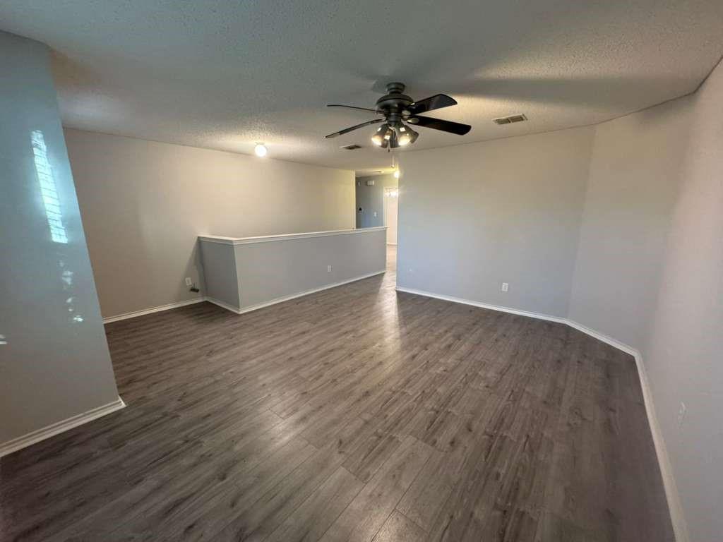 16516 Jasmine Springs Drive Fort Worth, TX 76247 - Photo 9 of 16 wooden floor in an empty room with a window