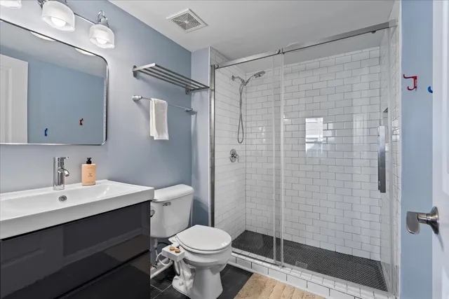 a bathroom with a shower toilet and sink