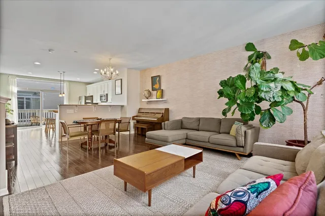 a living room with furniture and a potted plant