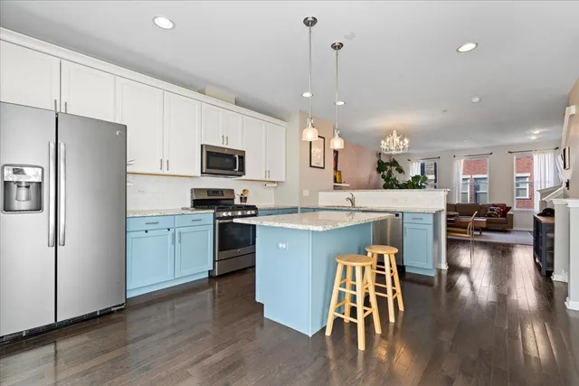 a kitchen with a sink a counter top space stainless steel appliances and cabinets