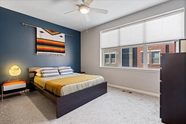 a bedroom with a bed and lamp