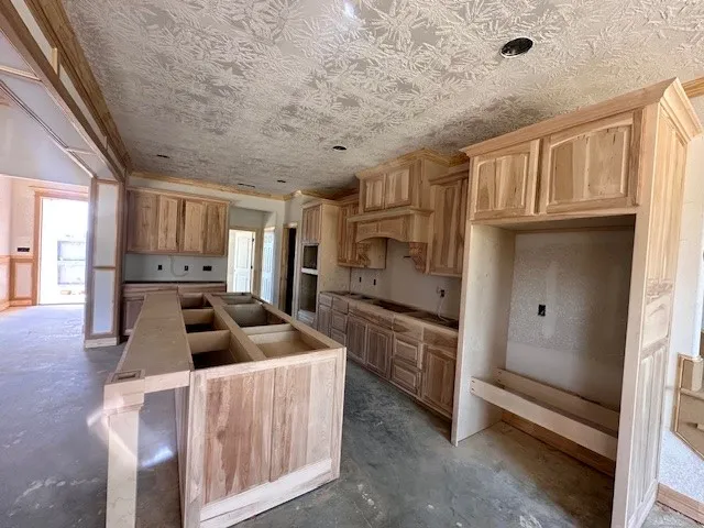 a view of kitchen with furniture and a refrigerator
