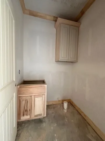 a view of a kitchen with a sink and dishwasher cabinets