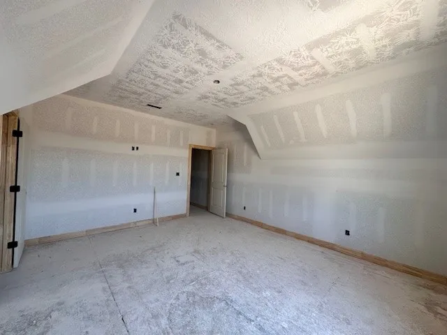 a view of a backyard with a table and chairs under an umbrella