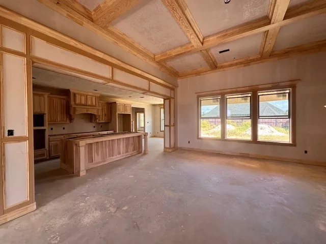 a view of empty room with cabinet and refrigerator