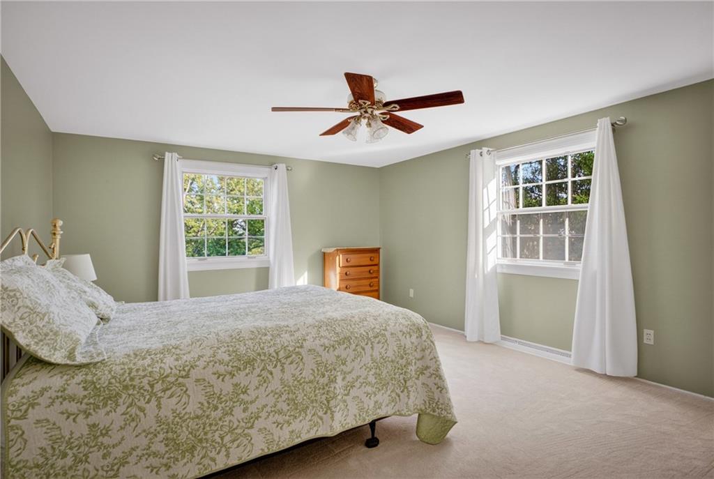 1243 Sun Ridge Drive Pittsburgh, PA 15241 - Photo 22 of 43 A serene primary bedroom showcasing soft neutral tones and clean lines. The versatile layout provides plenty of room for a full suite of furniture, while the large windows offer peaceful views of the surrounding property