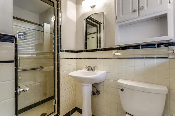 a bathroom with a sink toilet and mirror