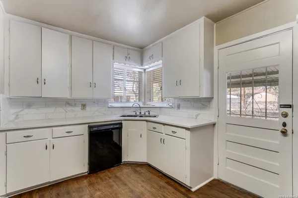 a kitchen with a sink stove and cabinets