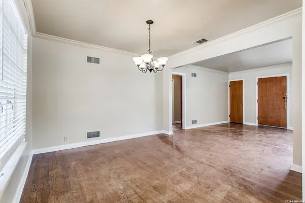 a view of a chandelier in big room and chandelier fan
