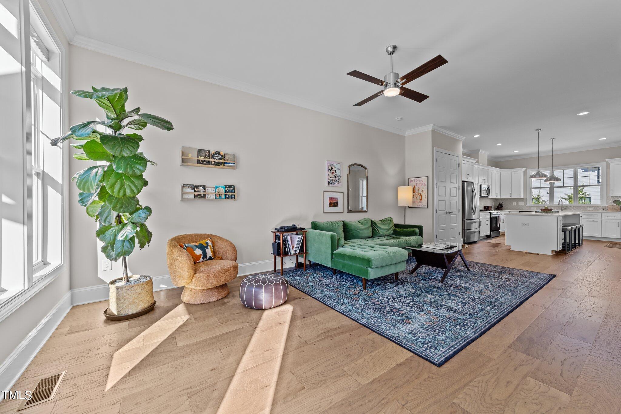 4936 Trek Lane Raleigh, NC 27606 - Photo 7 of 40 a living room with a couch and a potted plant