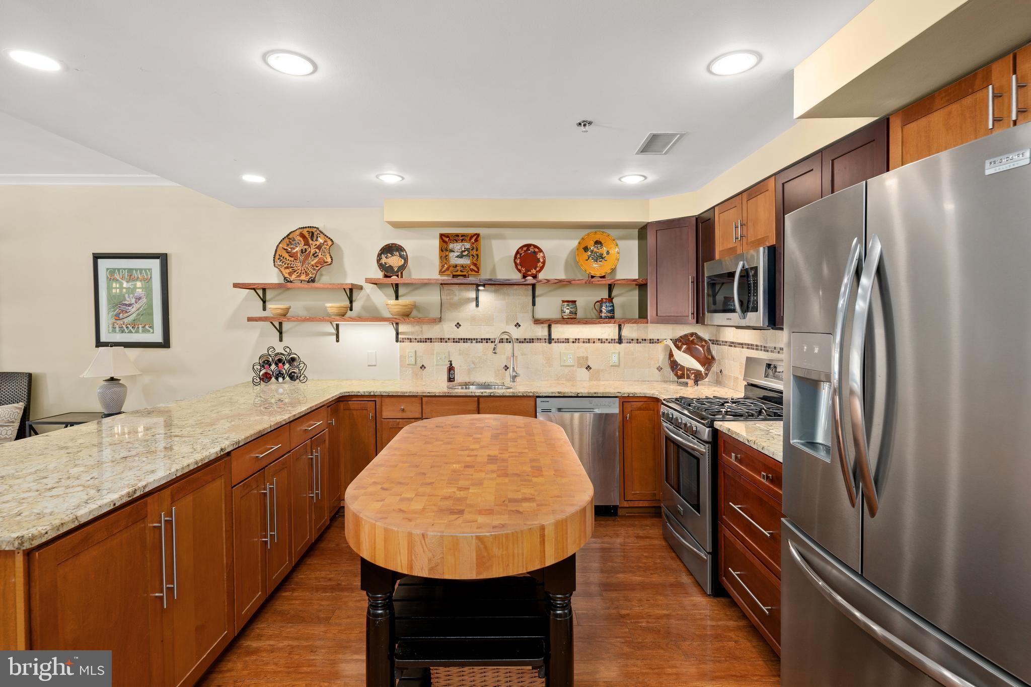 110 Anglers Road, Unit 206 Lewes, DE 19958 - Photo 12 of 40 a kitchen with stainless steel appliances granite countertop a sink refrigerator and cabinets