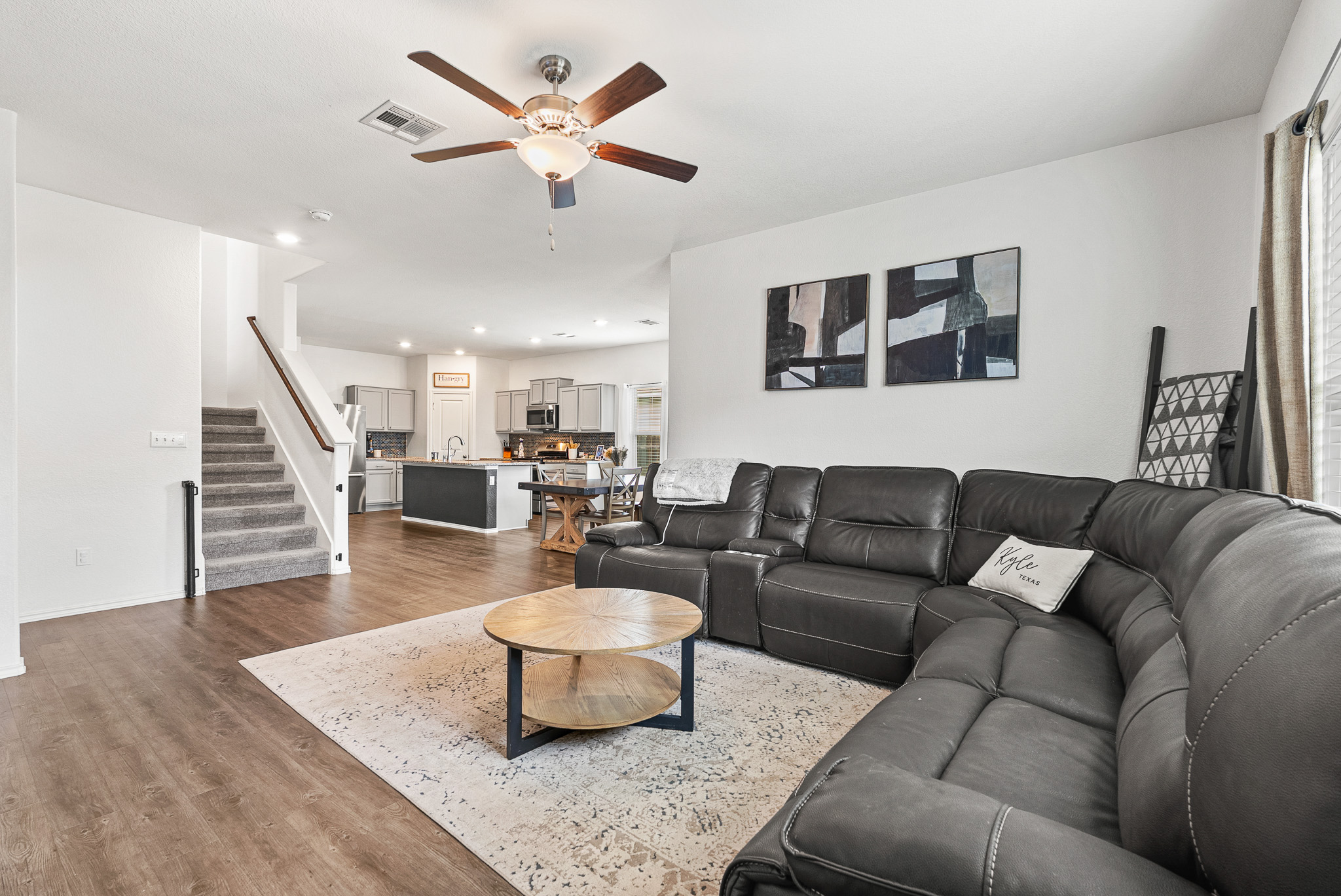 136 Copper Lane Kyle, TX 78640 - Photo 20 of 33 Living room featuring stairs, dark wood-type flooring, recessed lighting, ceiling fan, and healthy amount of natural light