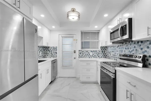 a kitchen that has a sink and a stove top oven