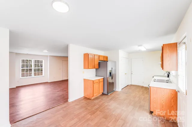 a spacious bathroom with a tub sink and mirror