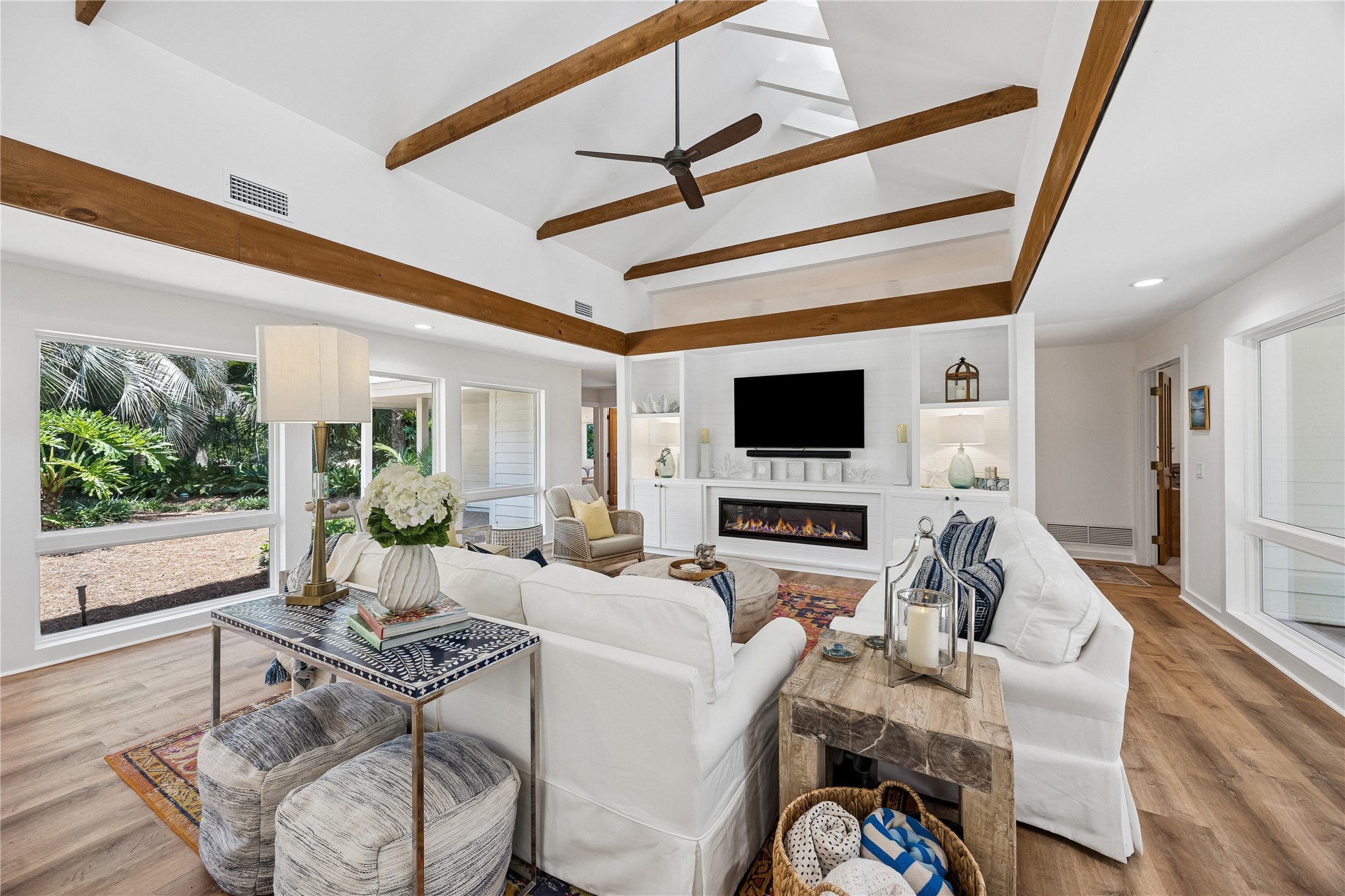 123 Bitternut Road Fernandina Beach, FL 32034 - Photo 2 of 87 Large Great Room features volume ceilings with exposed wood beams and is sandwiched between two walls of NEW windows bathing the room in a lovely ambiant light! Custom entertainment center with contemporary electric fireplace.