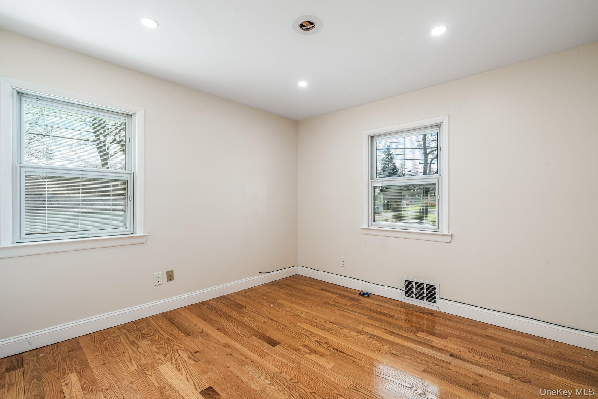 65 39th Street Islip, NY 11751 - Photo 12 of 30 a view of empty room with wooden floor and fan