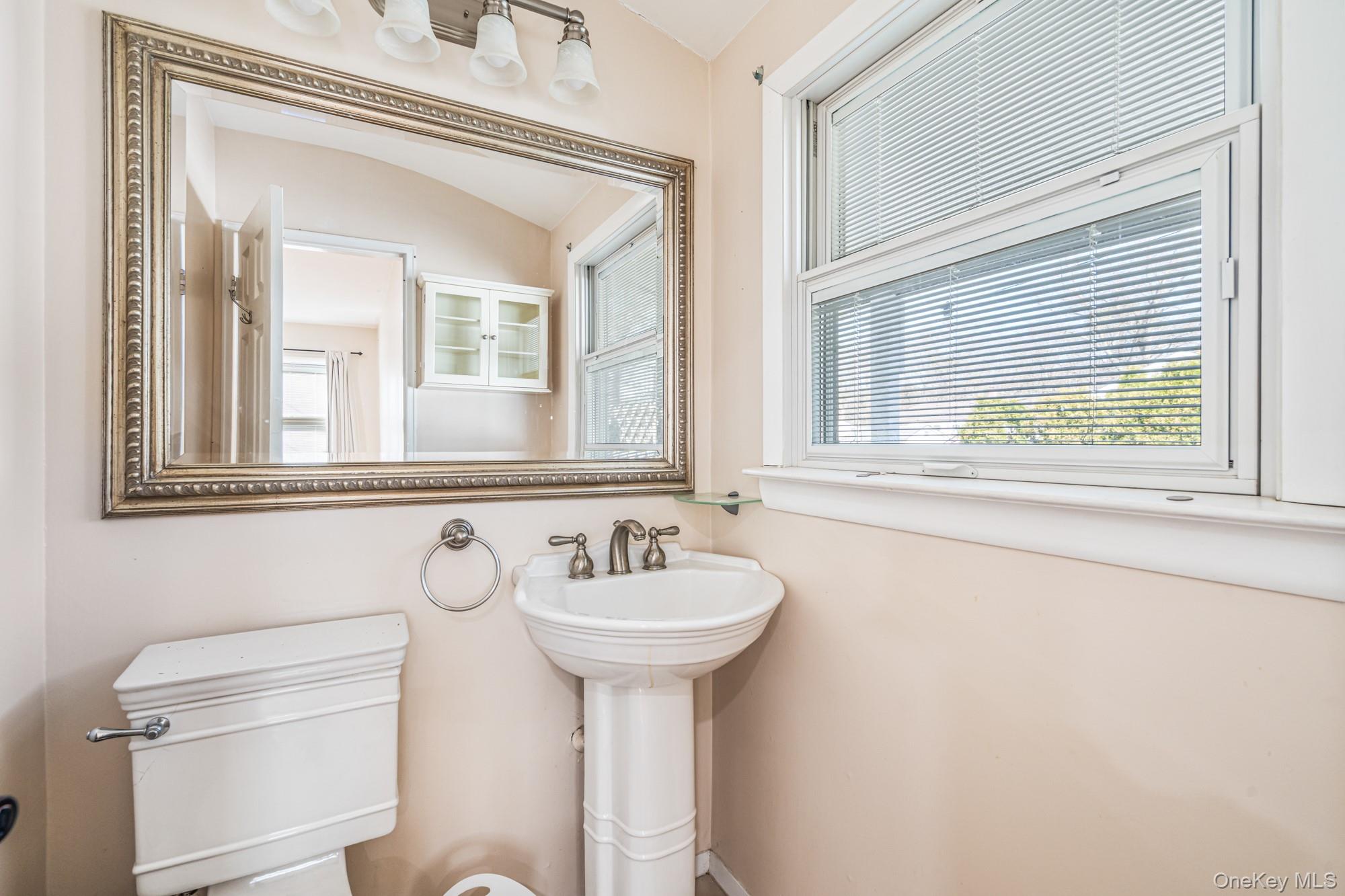 65 39th Street Islip, NY 11751 - Photo 14 of 30 a bathroom with a sink and a mirror