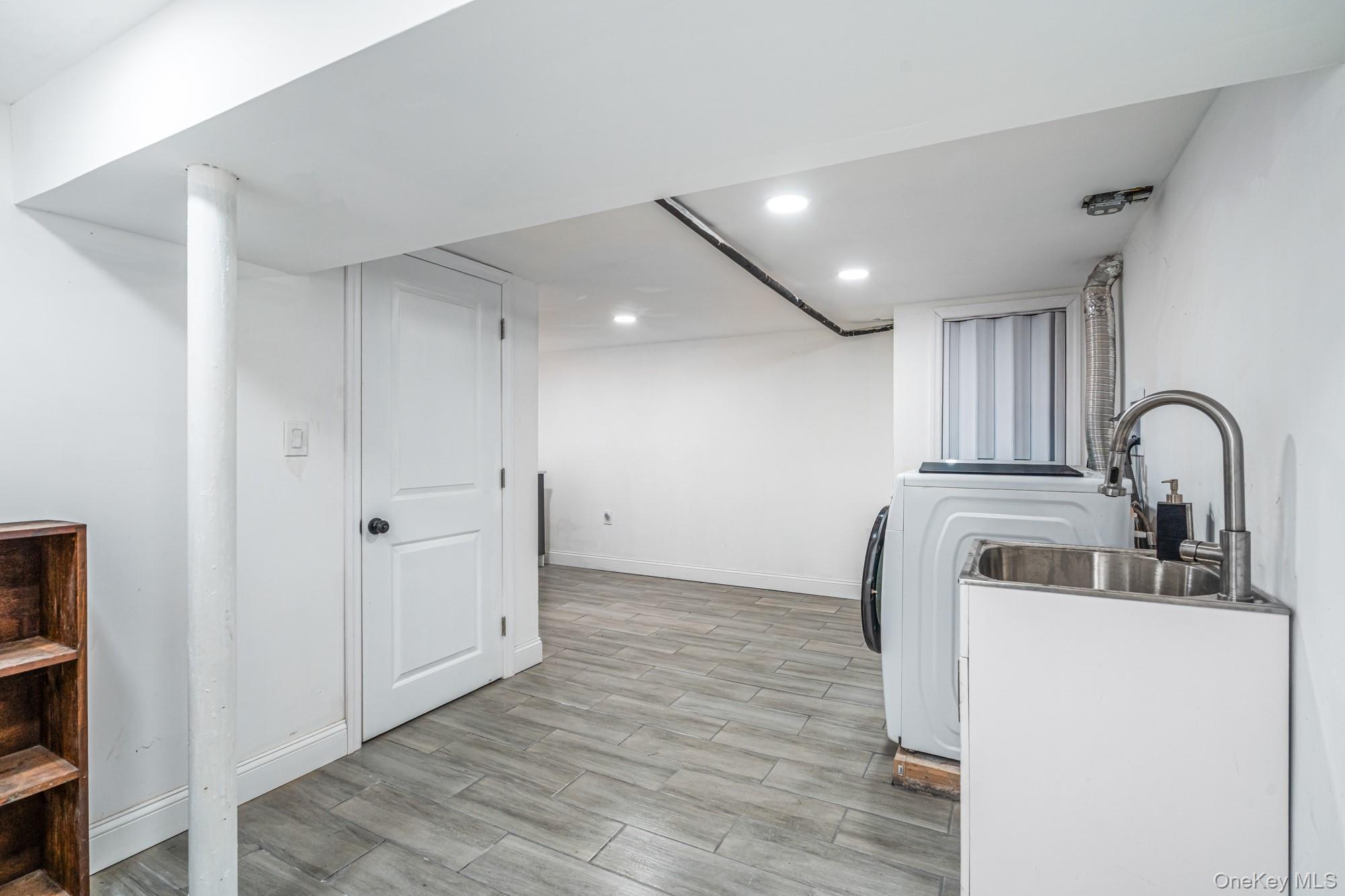 65 39th Street Islip, NY 11751 - Photo 19 of 30 a kitchen with a sink and a refrigerator