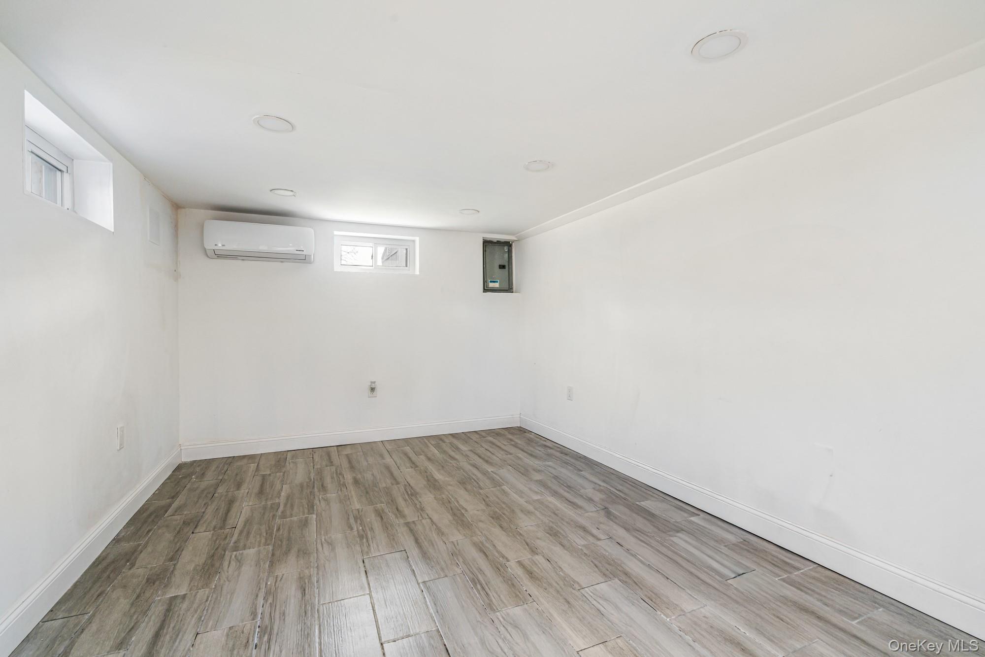65 39th Street Islip, NY 11751 - Photo 20 of 30 a view of a room with wooden floor and white walls