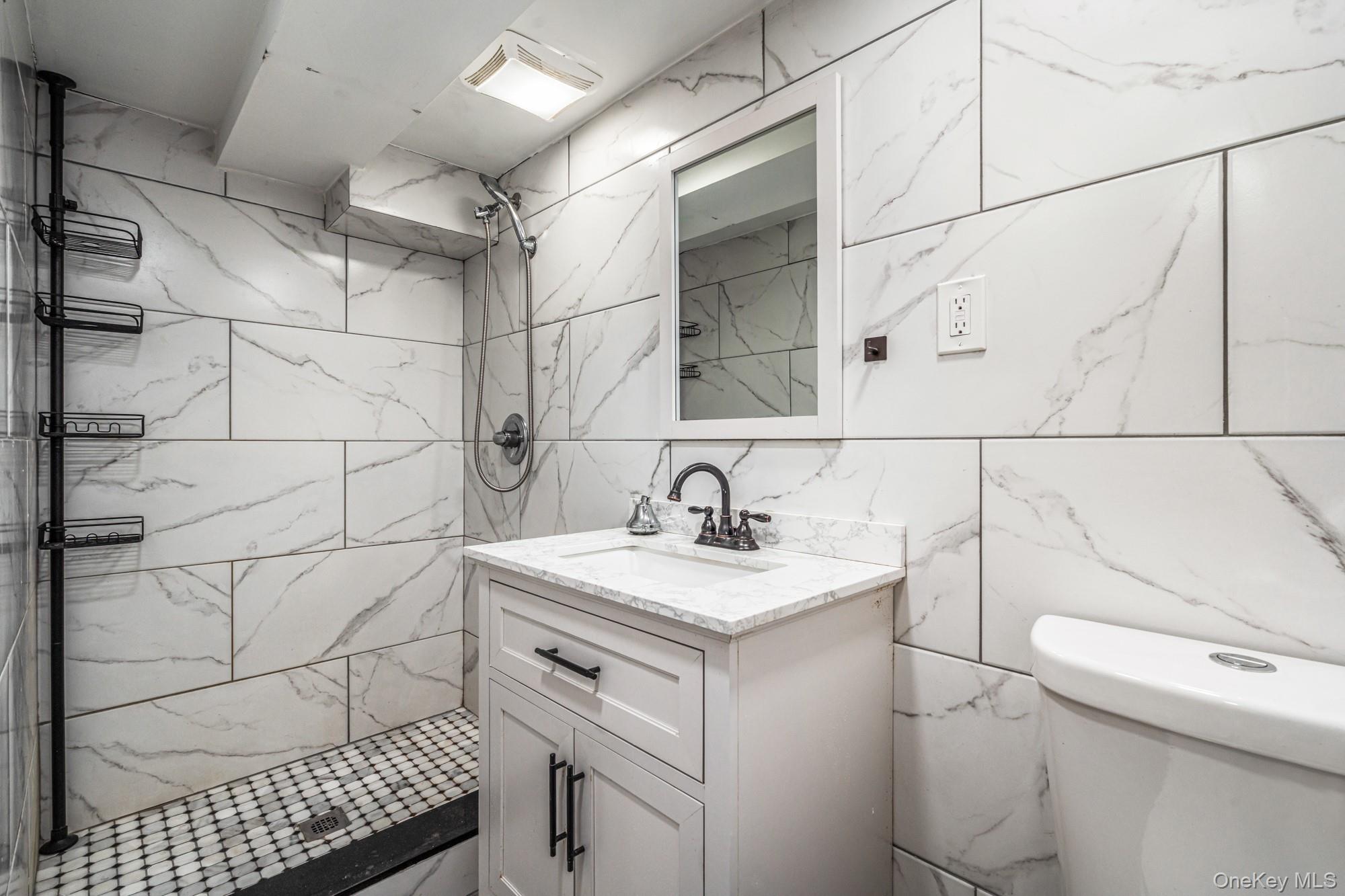 65 39th Street Islip, NY 11751 - Photo 21 of 30 a bathroom with a sink toilet and shower