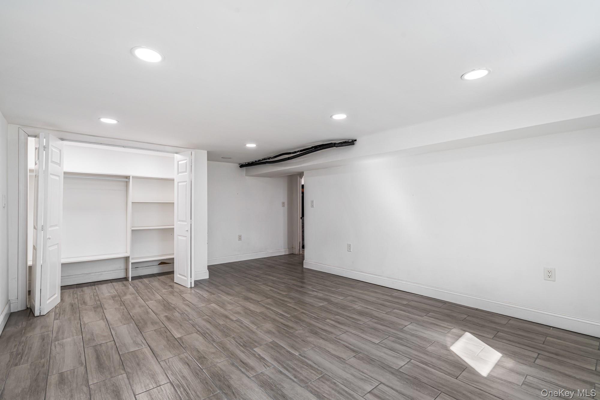 65 39th Street Islip, NY 11751 - Photo 23 of 30 a view of an empty room with wooden floor