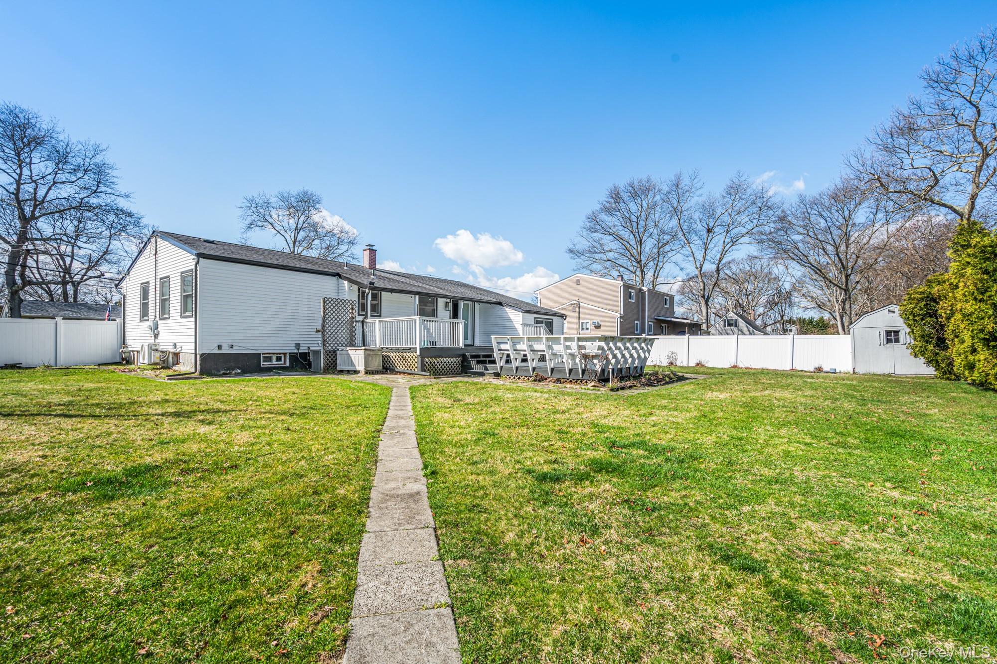 65 39th Street Islip, NY 11751 - Photo 27 of 30 a front view of a house with a yard table and chairs