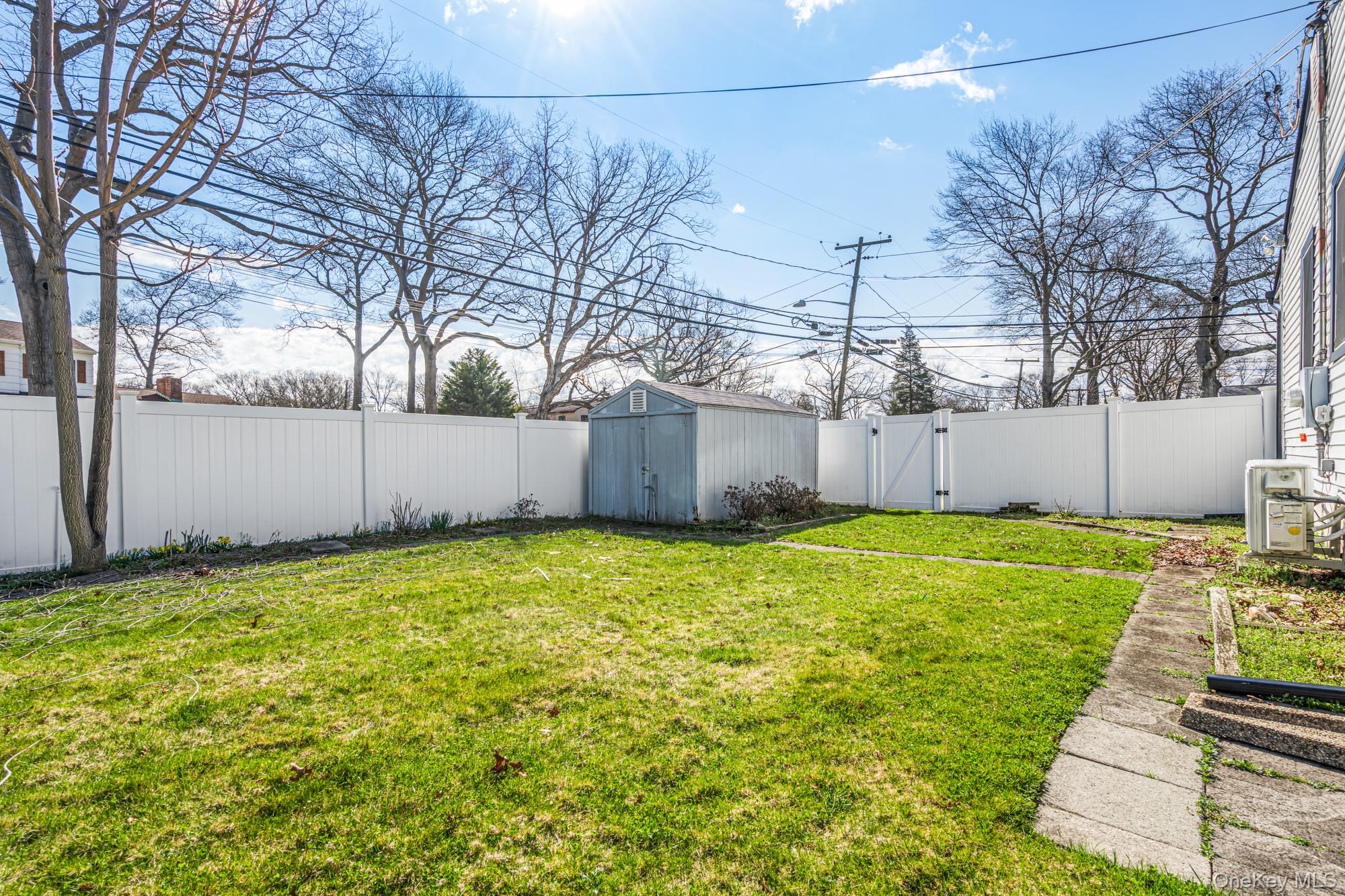 65 39th Street Islip, NY 11751 - Photo 28 of 30 a view of a backyard with a large tree