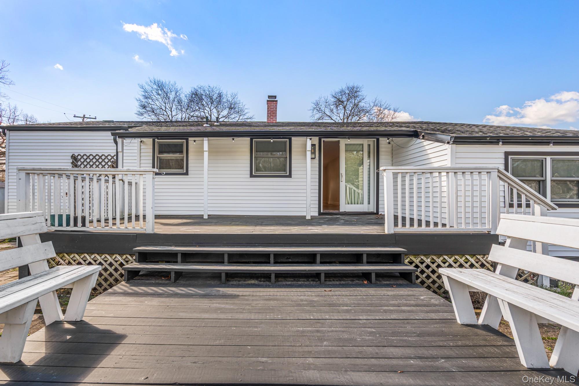 65 39th Street Islip, NY 11751 - Photo 29 of 30 a view of a house with a deck and furniture