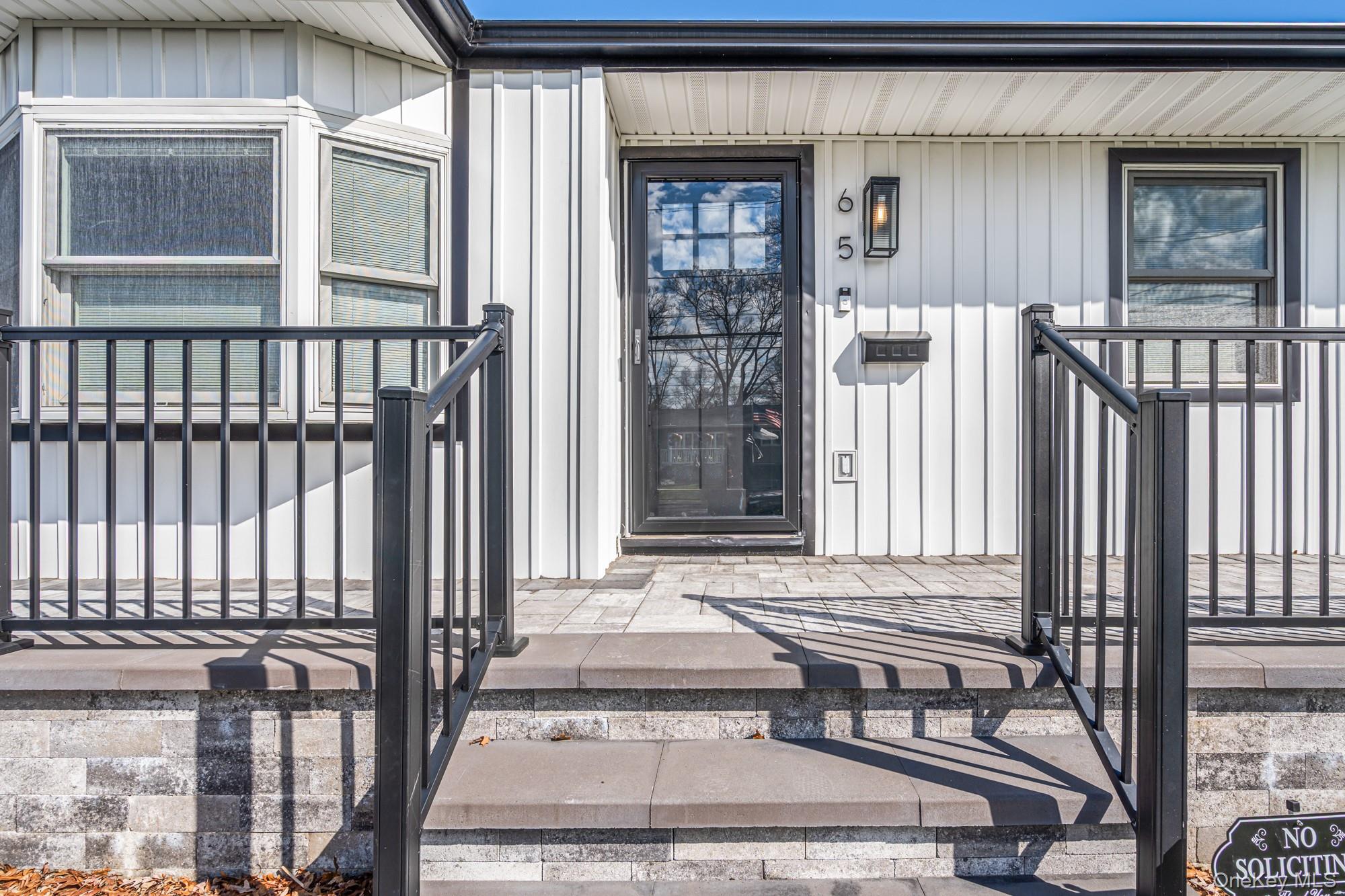 65 39th Street Islip, NY 11751 - Photo 3 of 30 a porch with a bench next to a door