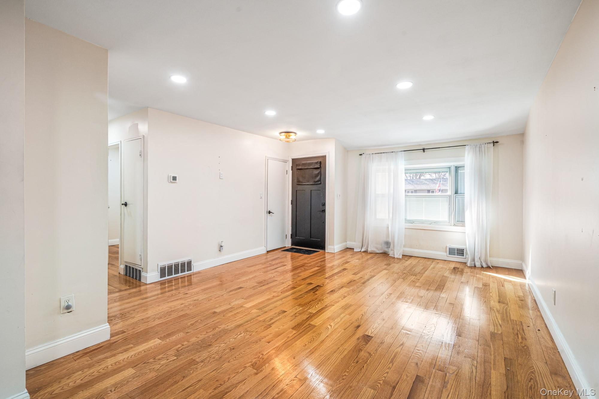 65 39th Street Islip, NY 11751 - Photo 5 of 30 a view of an empty room with wooden floor