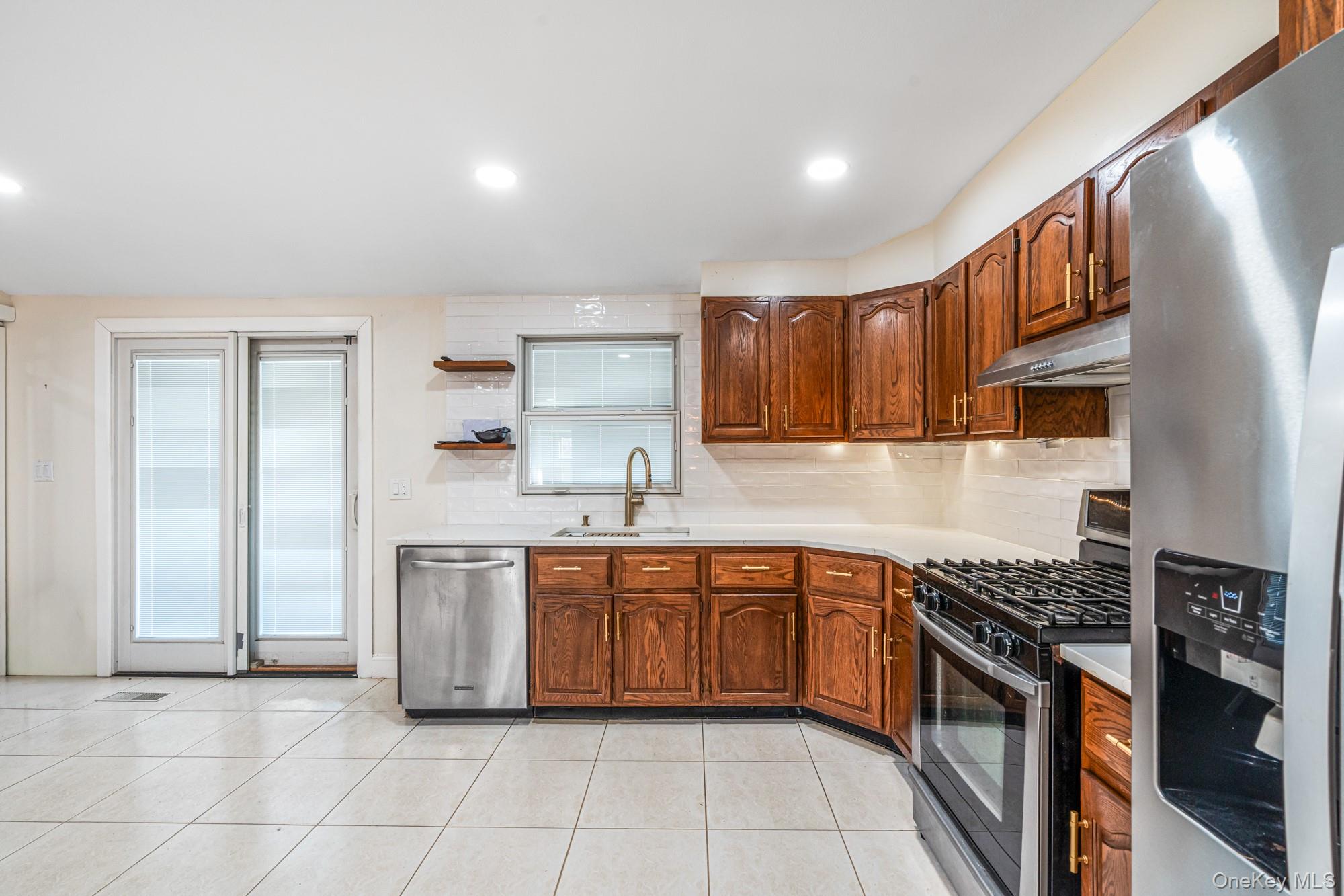 65 39th Street Islip, NY 11751 - Photo 8 of 30 a kitchen with stainless steel appliances granite countertop a sink and cabinets