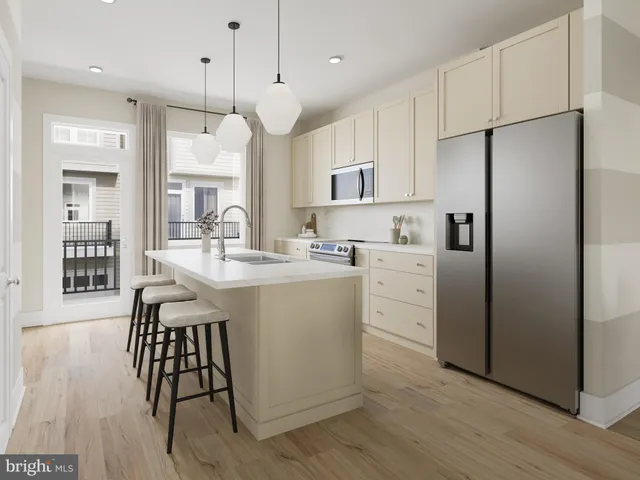 a kitchen with white cabinets stainless steel appliances and wooden floor
