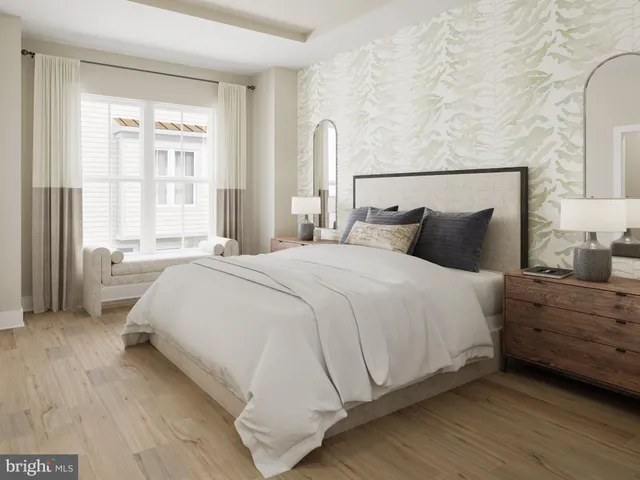 a bedroom with a bed and a large window