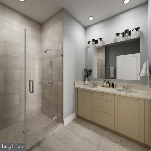 a bathroom with a double vanity sink mirror and shower