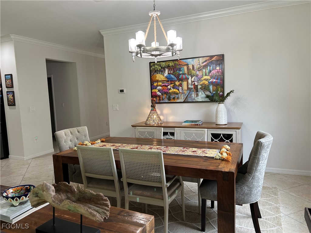 8963 Water Tupelo Road Fort Myers, FL 33912 - Photo 17 of 37 a view of a dining room with furniture a chandelier and wooden floor